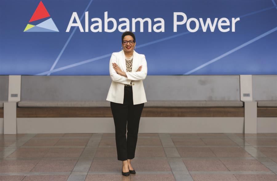 Staci Brown Brooks, Vice President of Charitable Giving for Alabama Power, smiles to camera, the AL Power logo behind her.